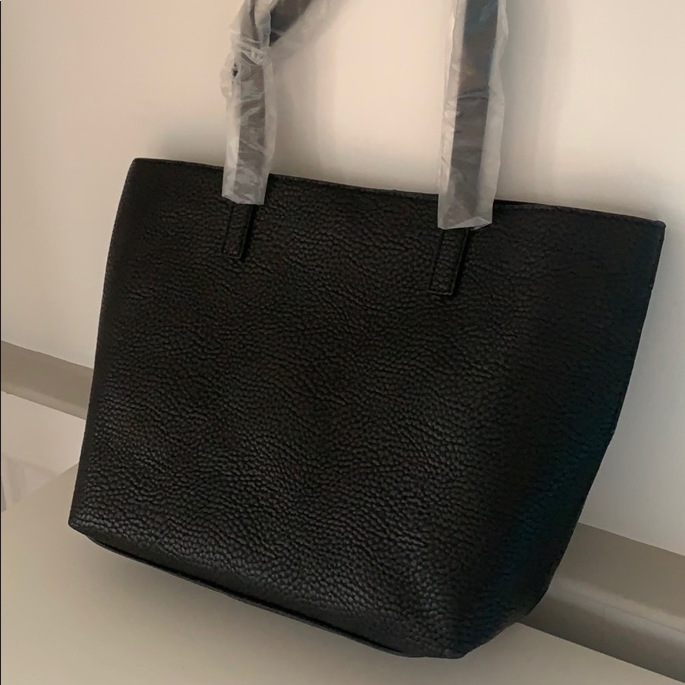 Barney’s black leather tote, perfect condition.